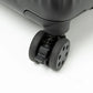 Close-up of a black suitcase wheel on a white background