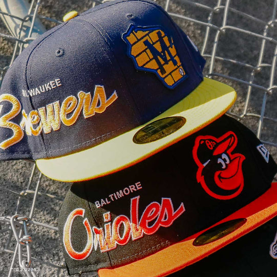 Milwaukee Brewers and Baltimore Orioles hats