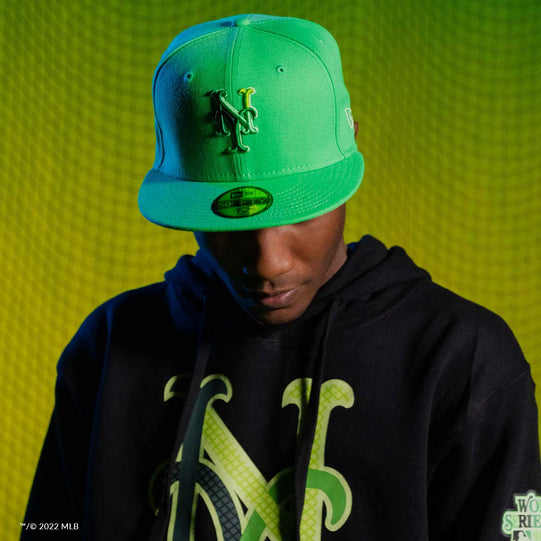 Man wearing a green NY hat and black NY sweatshirt