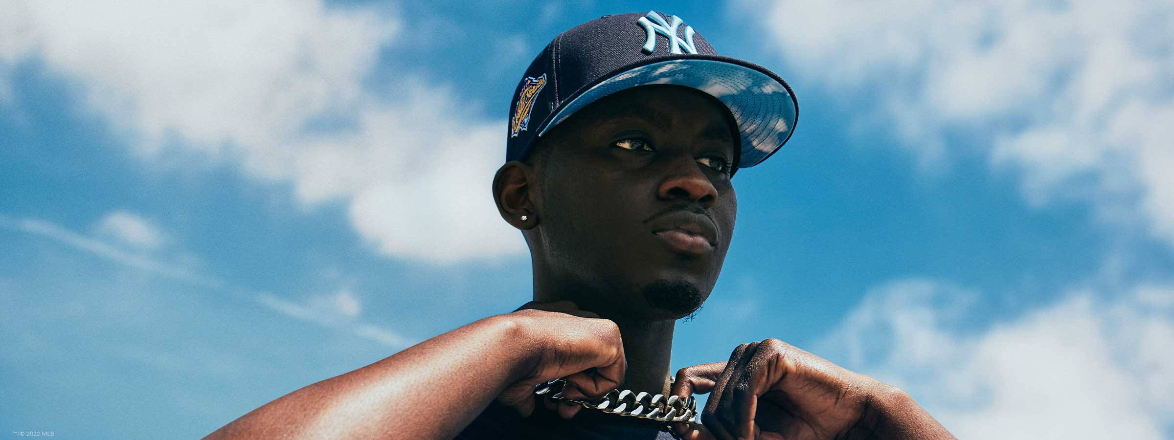 Man in New York Yankees Clouds collection hat and shirt
