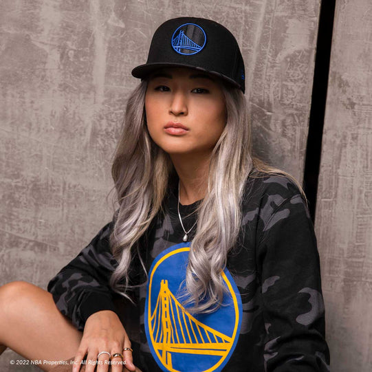 Girl in Golden State Warriors Lifestyle Camo T-Shirt and Hat